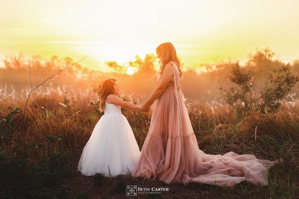 sunrise session of a mom and her daughter in beautiful gowns