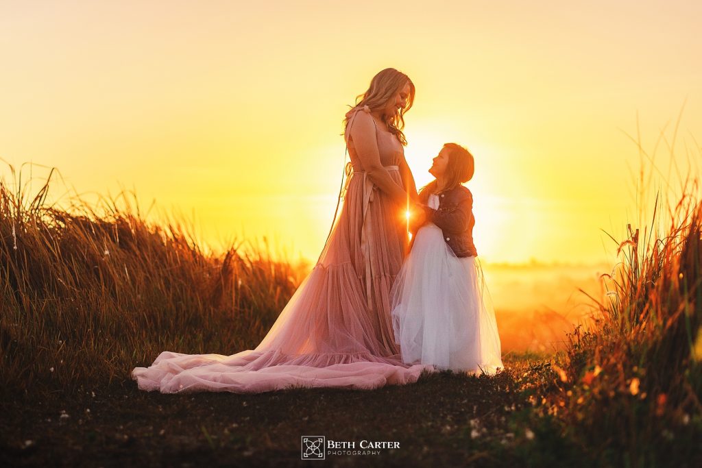 sunrise session of a mom and her daughter in beautiful gowns