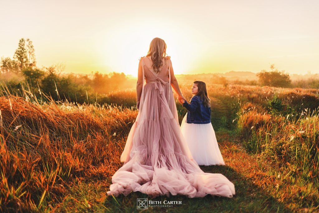 sunrise session of a mom and her daughter in beautiful gowns