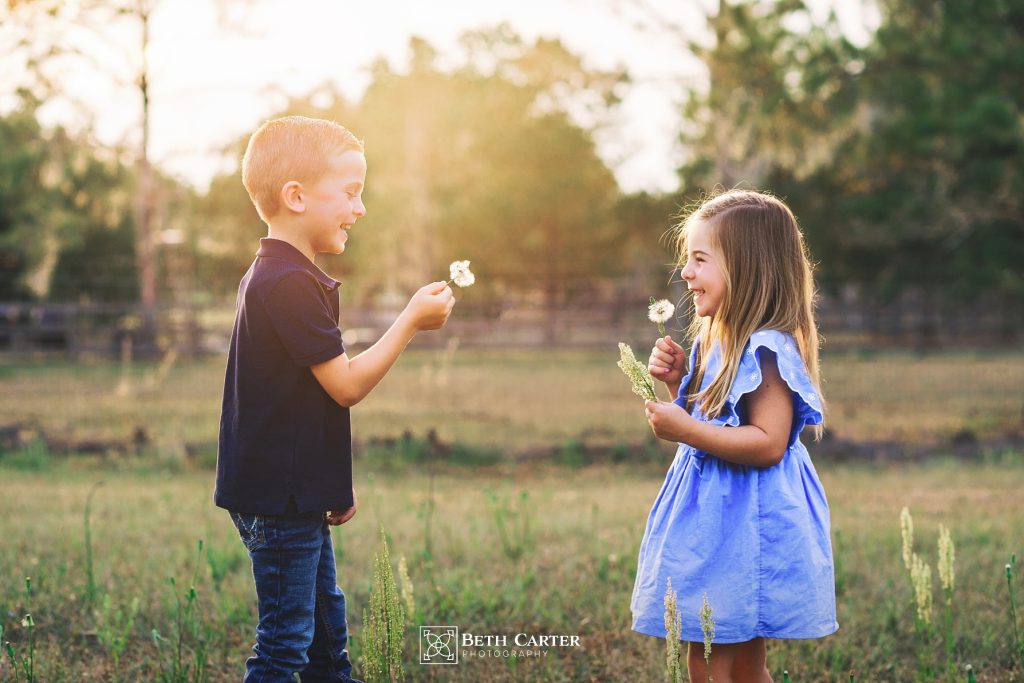 children playing with dandalions