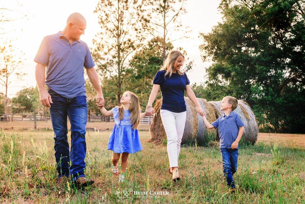 family photo in front of hay roll in Bartow, FL